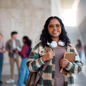 happy female student smiling in a college hallway